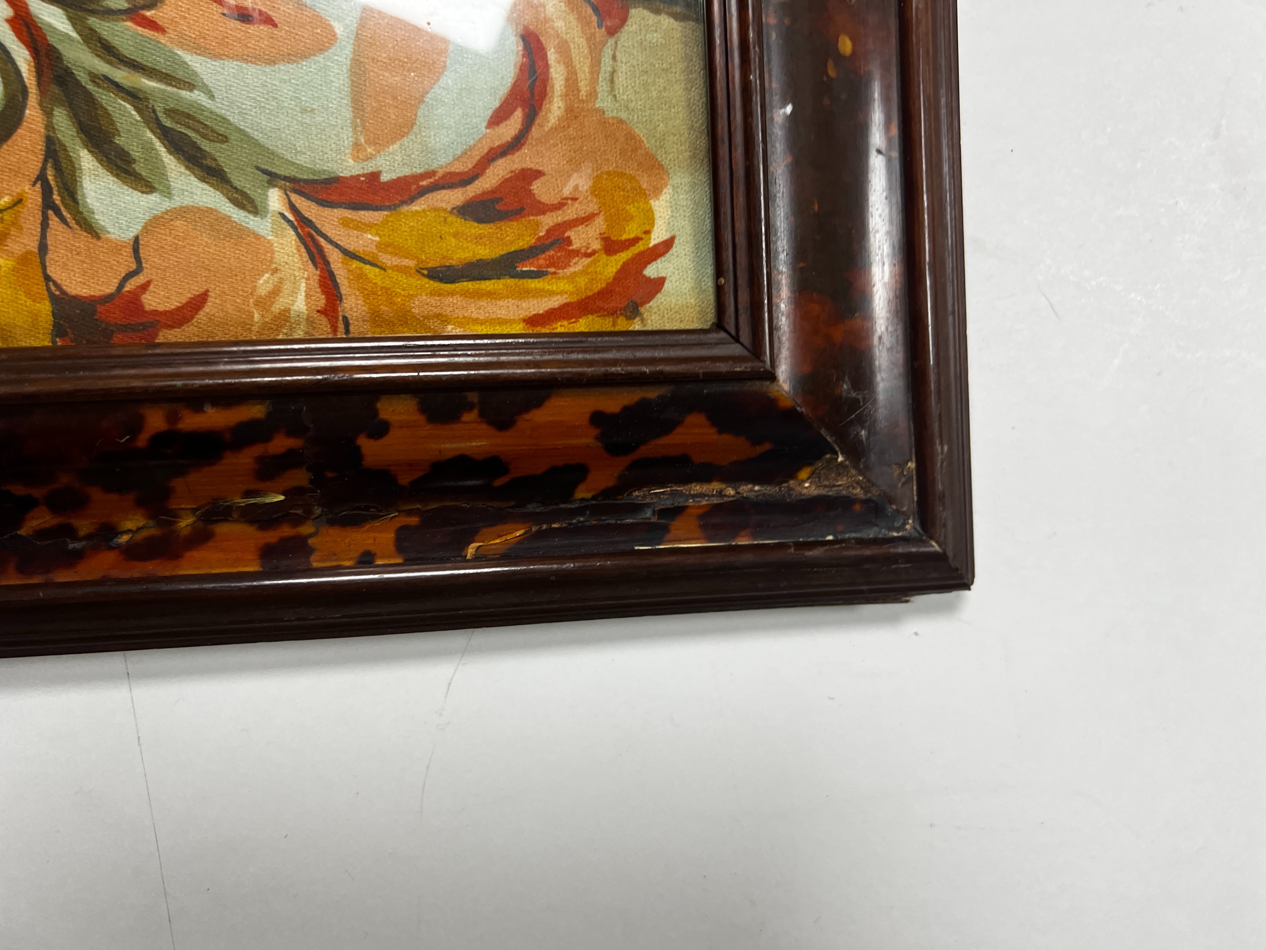 A large rare tortoiseshell picture frame and exotic panel of printed fabric, 70 cms wide x 52 cms high including frame